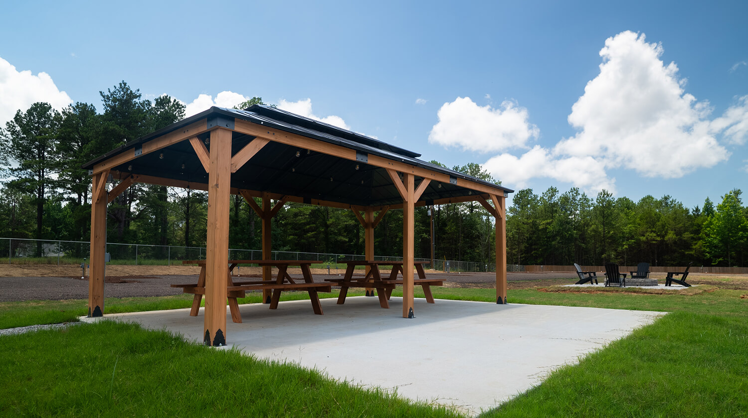 two picnic tables on covered pad