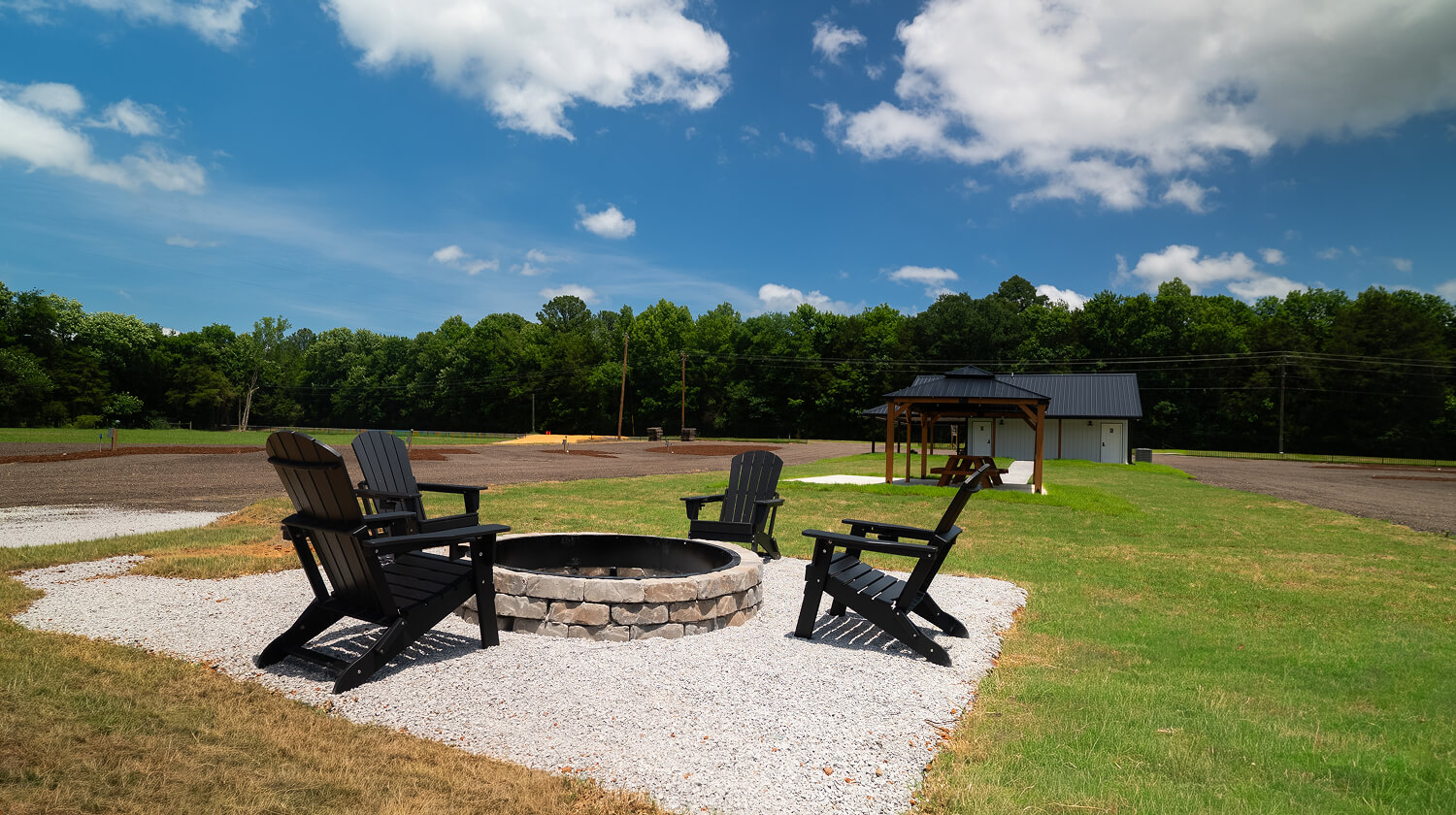 four adirondack chairs set around a fire pit